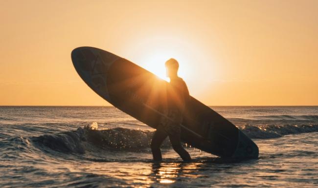 a person holding a surfboard in the water