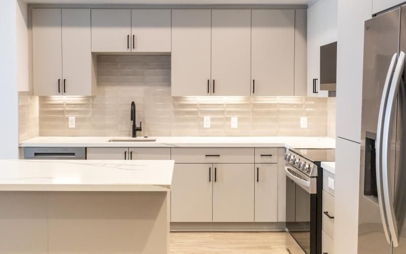 a kitchen with white cabinets