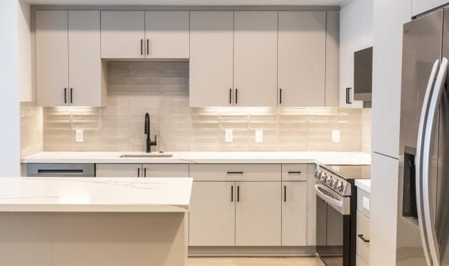 a kitchen with white cabinets