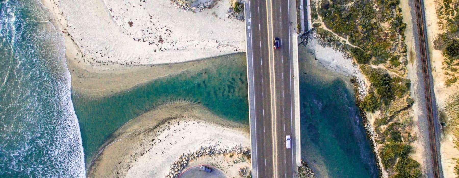 a road with water and trees